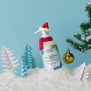 Avee Kids conditioning shampoo bottle with Santa hat in a snowy landscape with Christmas trees and ornaments.