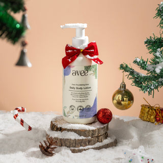 Avee daily body lotion with a red bow in a snowy scene with Christmas decorations.