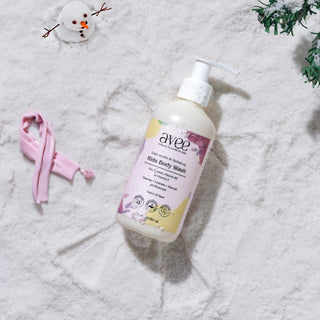 Avee Kids Body Wash bottle on a snowy background with a small snowman and pink lanyard.